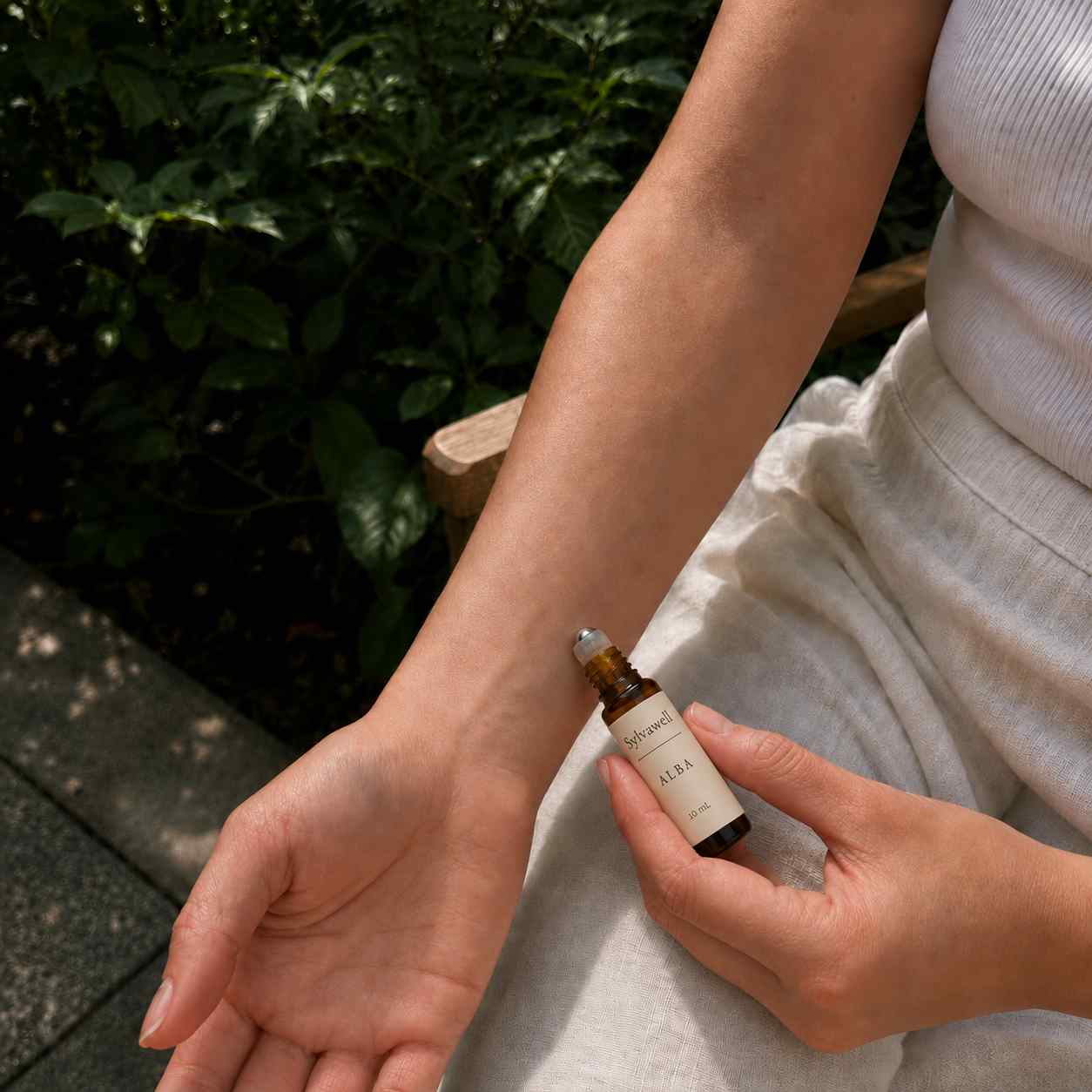 Woman applying 100% natural fragrance Alba Sylvawell