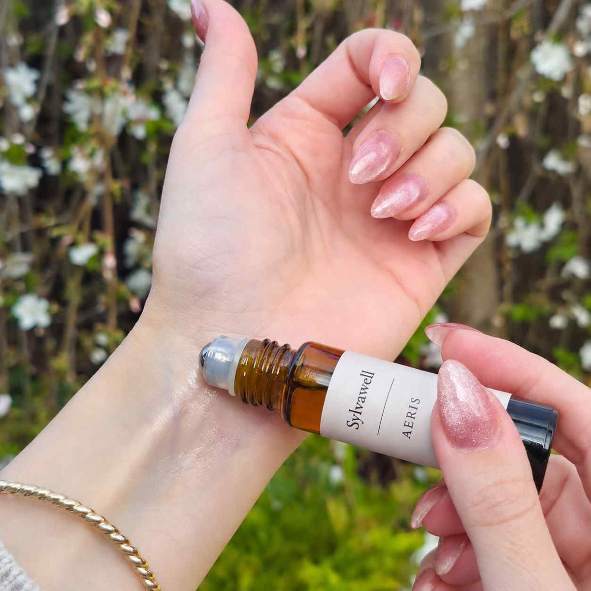 100% natural fragrance woman applying Aeris 