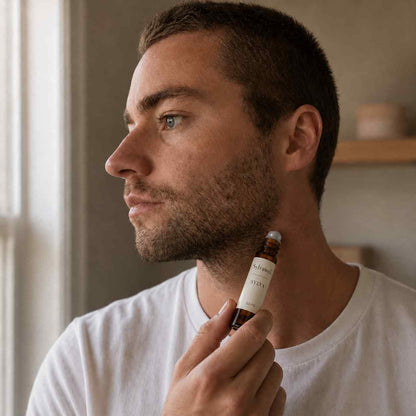 Man applying Sylvawell Sylva natural roll-on fragrance to neck - synthetic-free men's perfume Australia